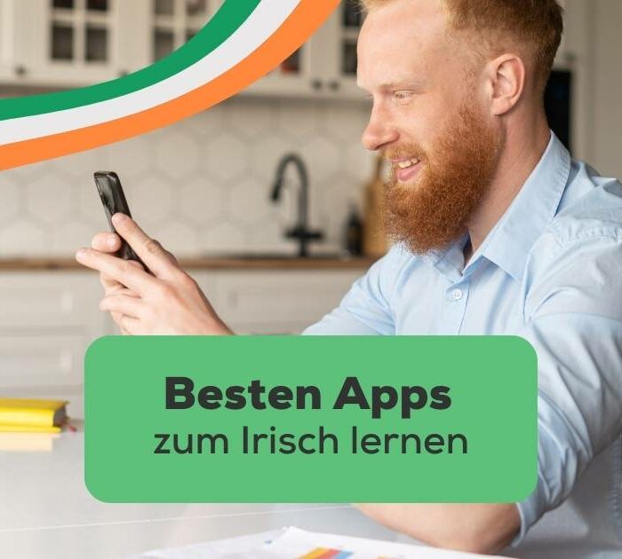 Rothaariger Mann schaut freudig in sein Handy und freut sich mit Ling die besten Apps zum Irisch lernen gefunden zu haben