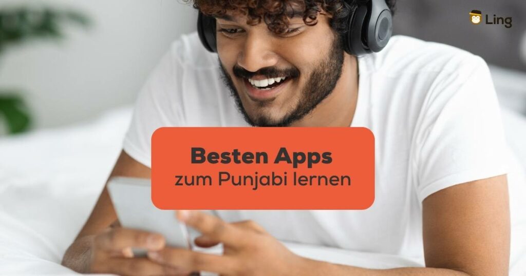 Dunkelhaariger Mann hat schwarze Kopfhörer an und Handy in der Hand und sucht nach den Besten Apps zum Punjabi lernen mit der Ling-App