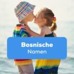 Junge und Mädchen am Meer geben sich spielerisch einen Kuss und haben bosnische Namen