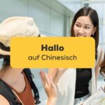 Drei asiatische Freundinnen begrüßen sich mit Hallo auf Chinesisch