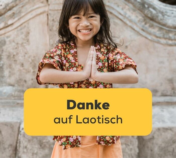 Laotisches Mädchen macht den Nop um Danke auf Laotisch zu sagen