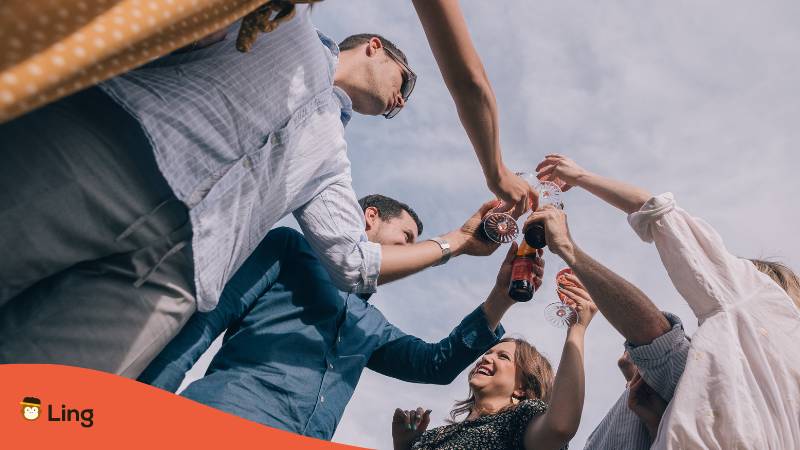 Gruppe Slowenen stossen miteinander an sagen dabei Prost auf Slowenisch und sind ziemlich trinkfest