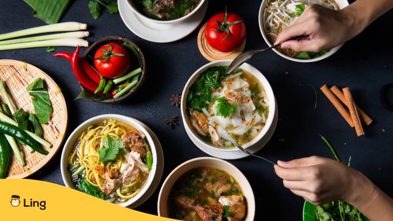 Tisch mit unterschiedlichen Gerichten mit malaysischen Aromen
